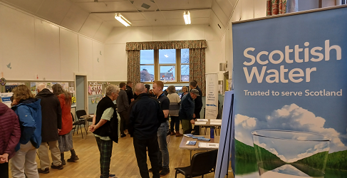 Attendees are shown speaking to staff at an Information Event in Lower Largo