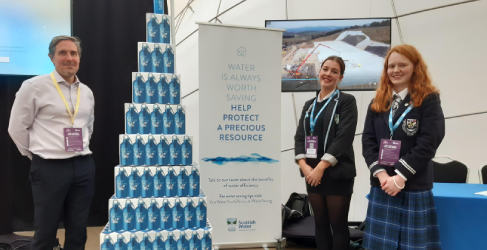Scottish Water employee at stand alongside 2 pupils at Fuel Change Live Event